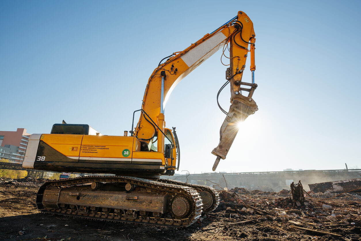Power Demolition excavator working on an industrial demolition site